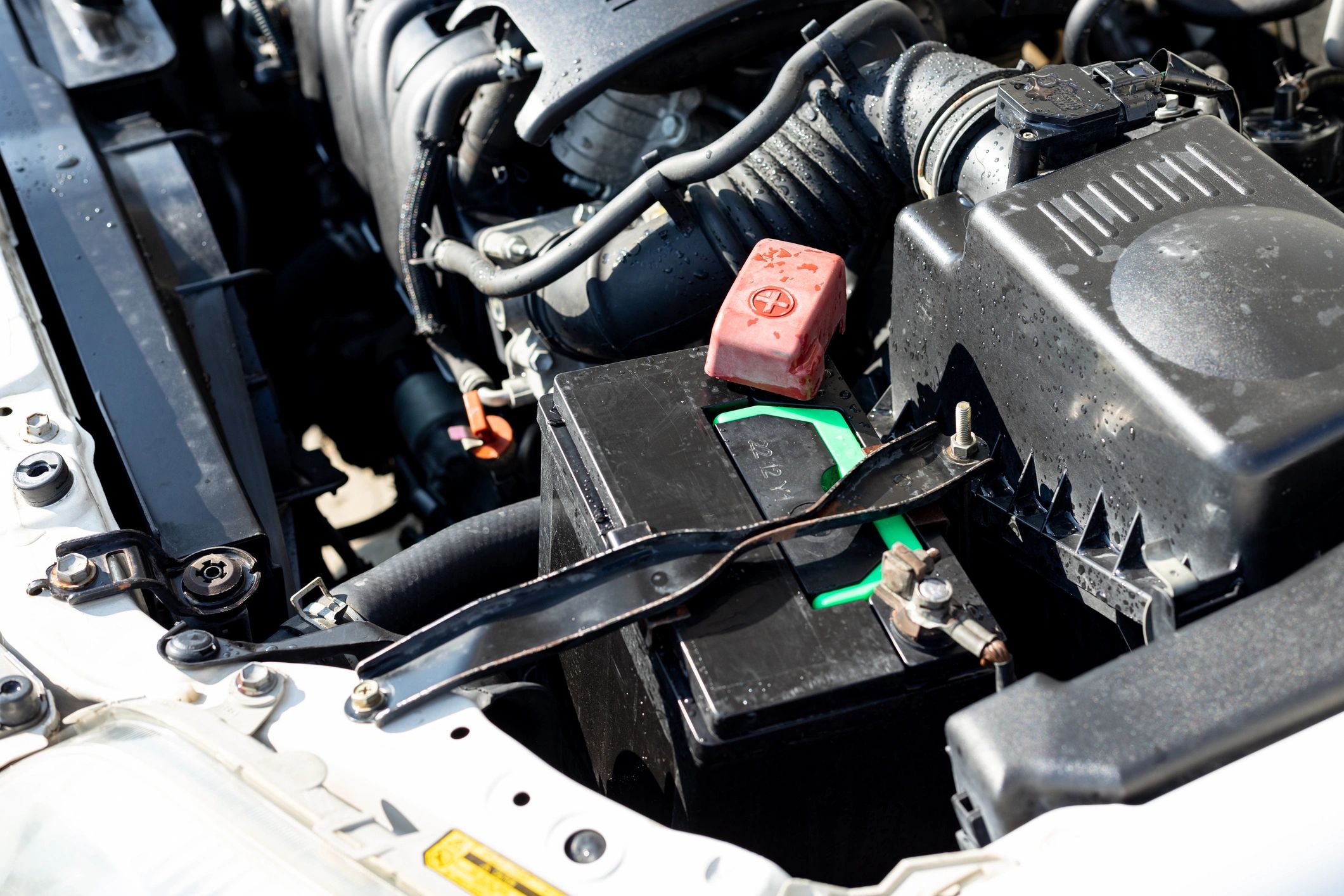 Car battery installed in an engine compartment