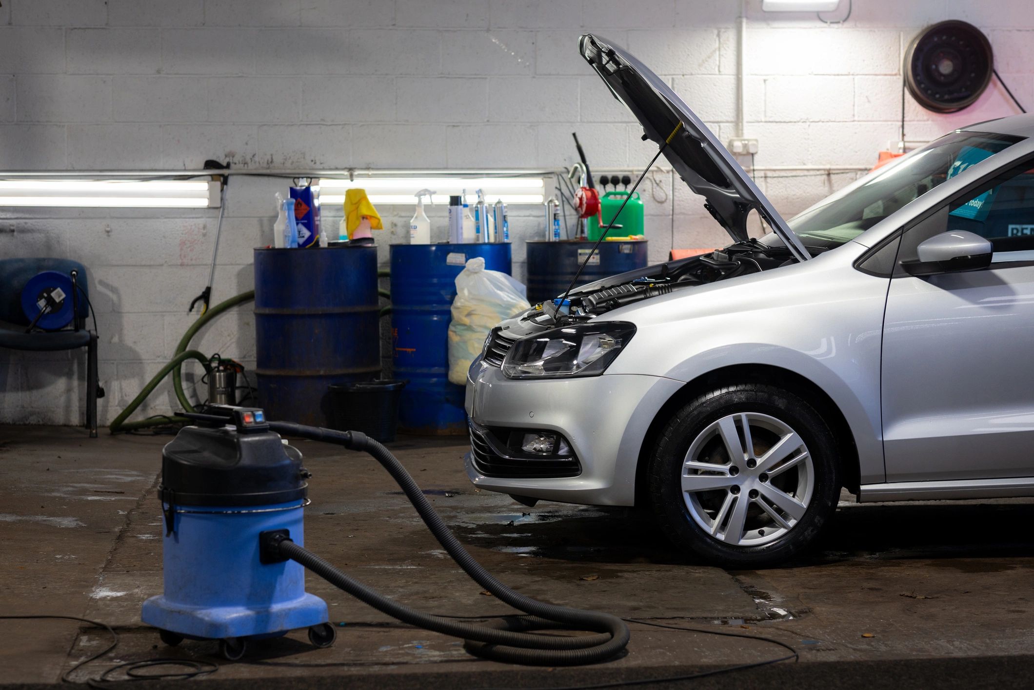 Car in a workshop bay prepared for cleaning and service